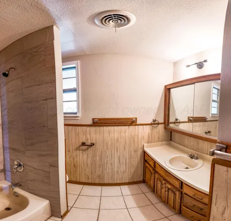 a bathroom with a sink a mirror and a shower