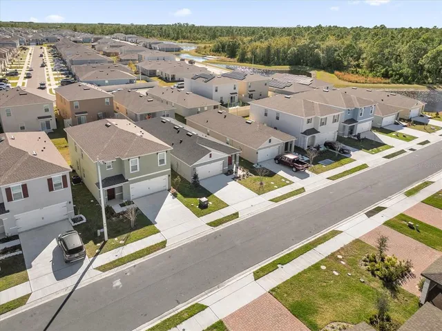 an aerial view of residential houses with outdoor space