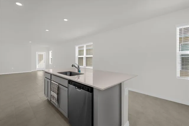 a kitchen with sink cabinets and window