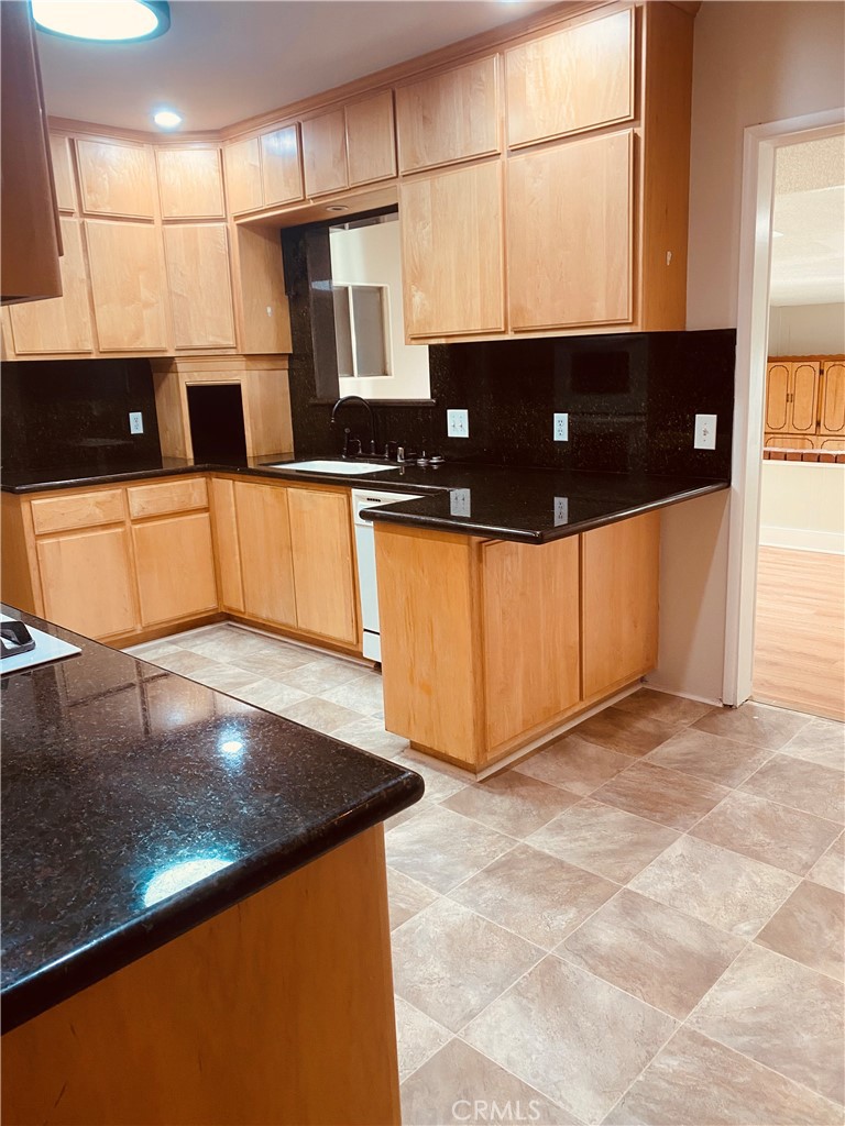 11745 Bryant Street Yucaipa, CA 92399 - Photo 13 of 28 a view of a kitchen with stainless steel appliances granite countertop a sink a stove and a microwave