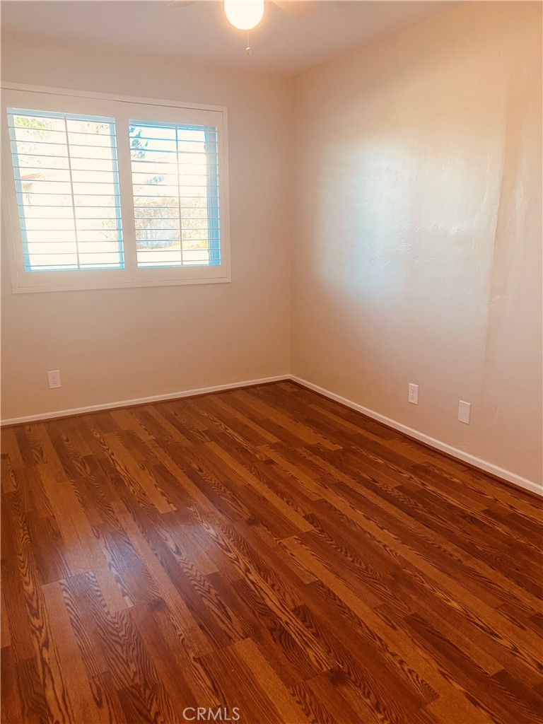 11745 Bryant Street Yucaipa, CA 92399 - Photo 20 of 28 an empty room with wooden floor and windows