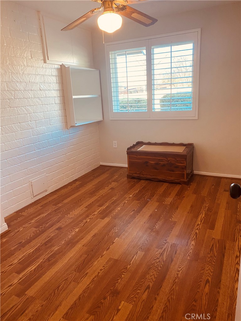 11745 Bryant Street Yucaipa, CA 92399 - Photo 21 of 28 an empty room with wooden floor and windows