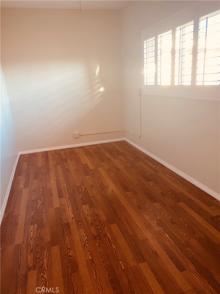 11745 Bryant Street Yucaipa, CA 92399 - Photo 23 of 28 an empty room with wooden floor and windows