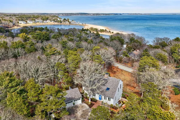 an aerial view of beach and residential building with outdoor space
