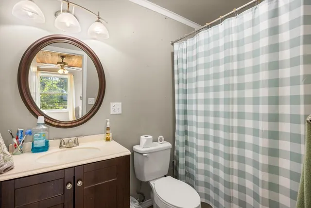 a bathroom with a sink a toilet and a mirror