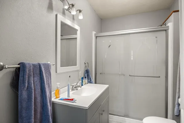 a bathroom with a sink toilet and shower