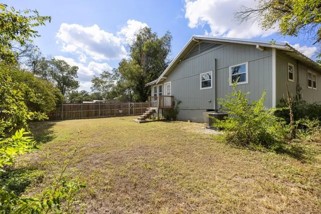 a backyard of a house with plants and trees