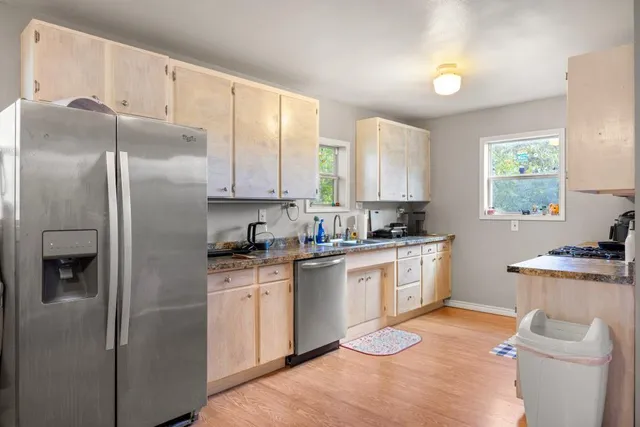 a kitchen with a sink stove and refrigerator