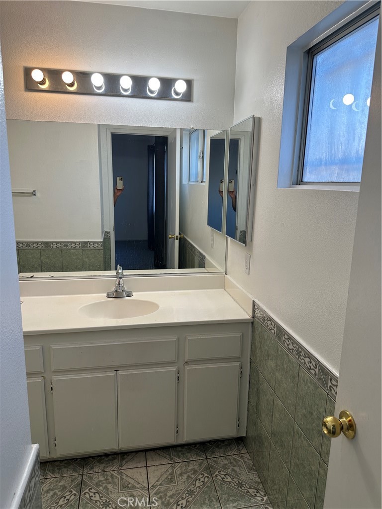 8505 Robinia Street Fontana, CA 92335 - Photo 12 of 30 a bathroom with a sink and mirror