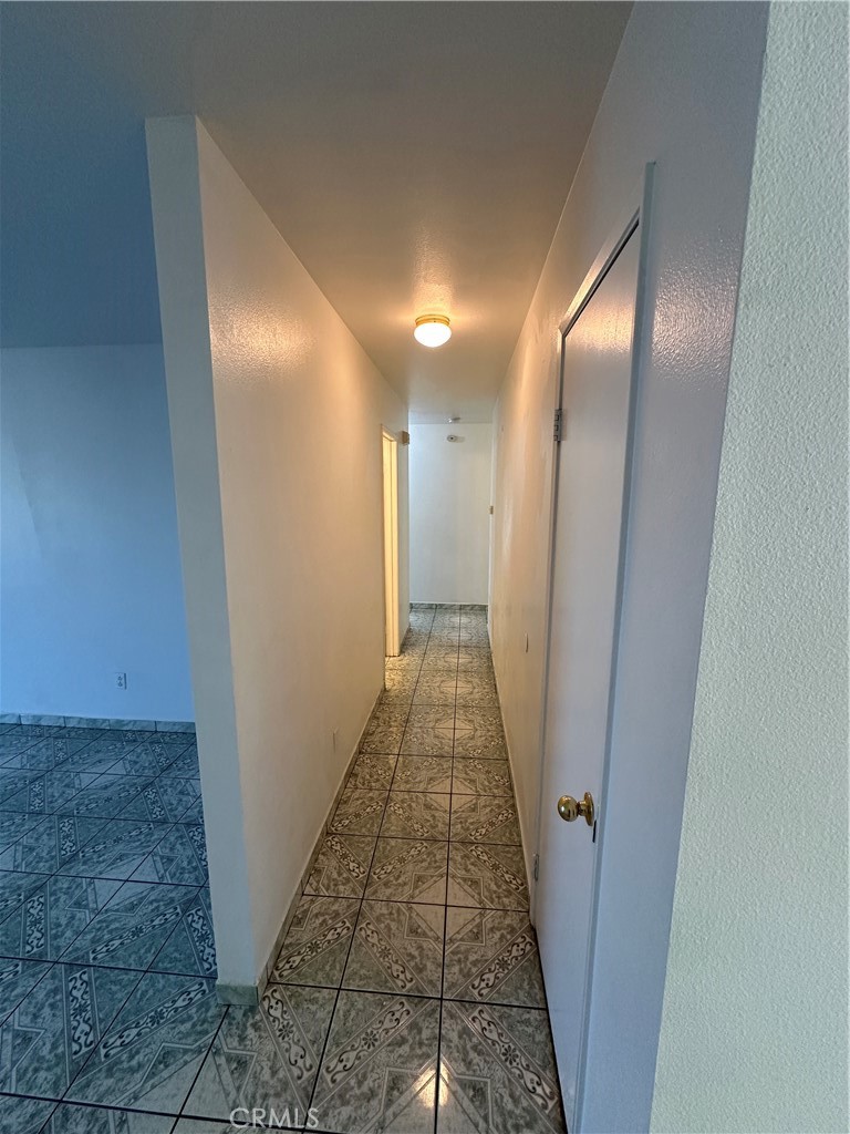 8505 Robinia Street Fontana, CA 92335 - Photo 19 of 30 a view of a hallway with a glass door