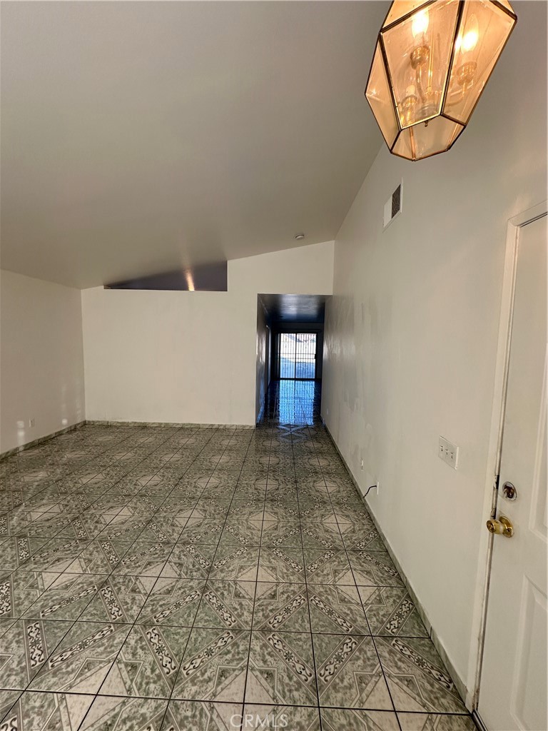 8505 Robinia Street Fontana, CA 92335 - Photo 23 of 30 a view of a hallway with wooden floor and entryway