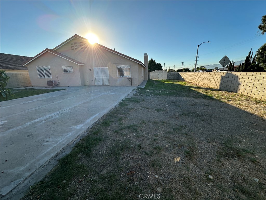 8505 Robinia Street Fontana, CA 92335 - Photo 29 of 30 a front view of house with a yard and garage