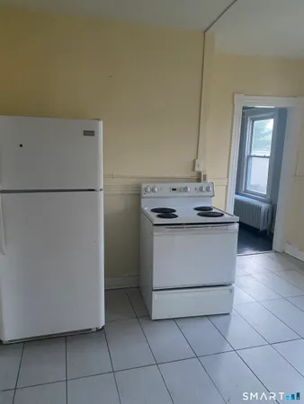 a kitchen with a stove top oven and cabinets