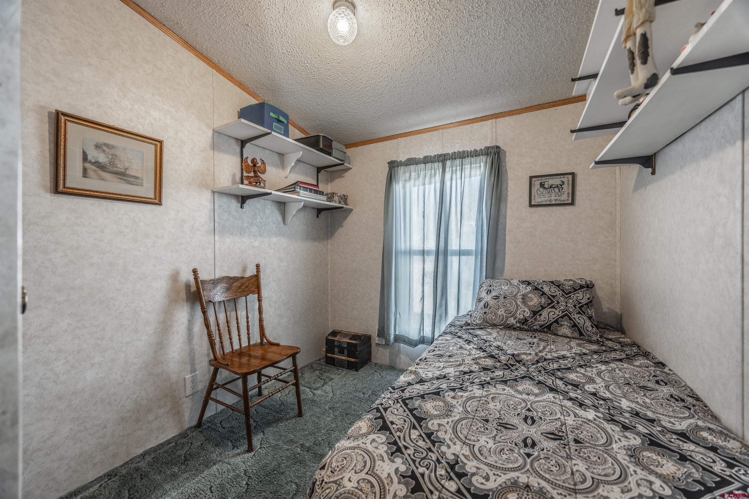 9713 Kebler Road, Unit 28 Austin, CO 81410 - Photo 13 of 25 a bedroom with furniture and a window