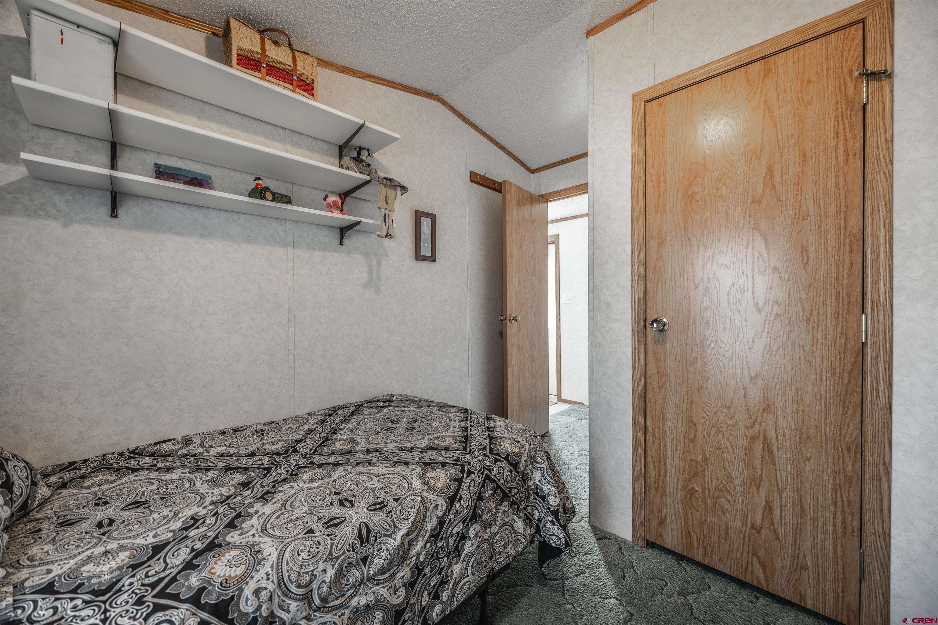 9713 Kebler Road, Unit 28 Austin, CO 81410 - Photo 14 of 25 a bedroom with a bed and cabinets