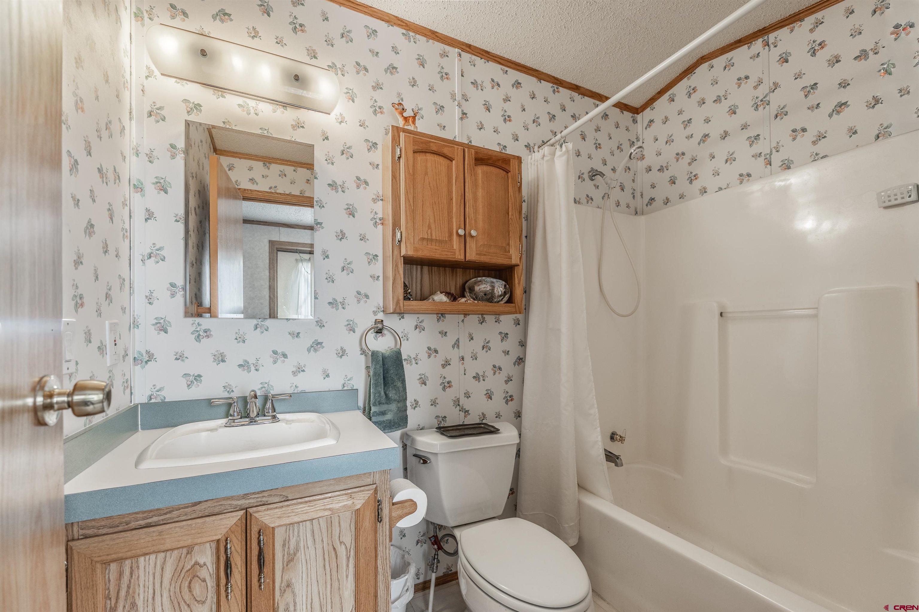 9713 Kebler Road, Unit 28 Austin, CO 81410 - Photo 16 of 25 a bathroom with a granite countertop sink toilet and shower
