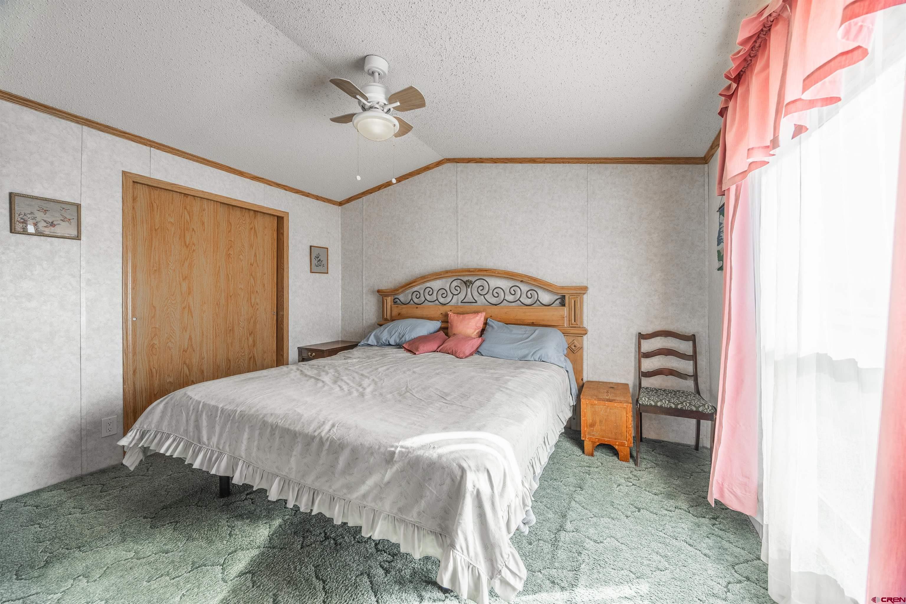 9713 Kebler Road, Unit 28 Austin, CO 81410 - Photo 17 of 25 a bedroom with a bed and a window