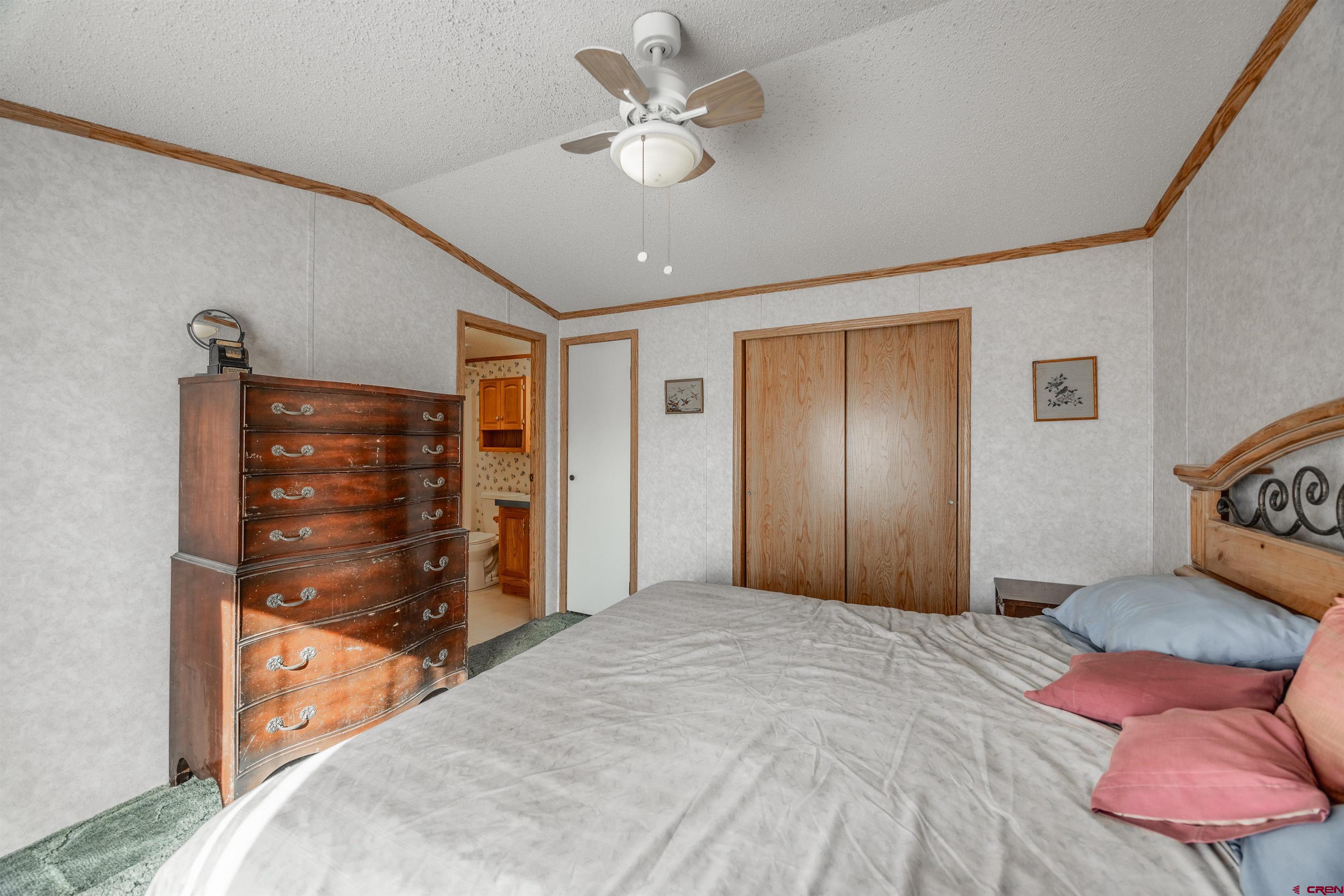 9713 Kebler Road, Unit 28 Austin, CO 81410 - Photo 18 of 25 a bedroom with a bed and a dresser