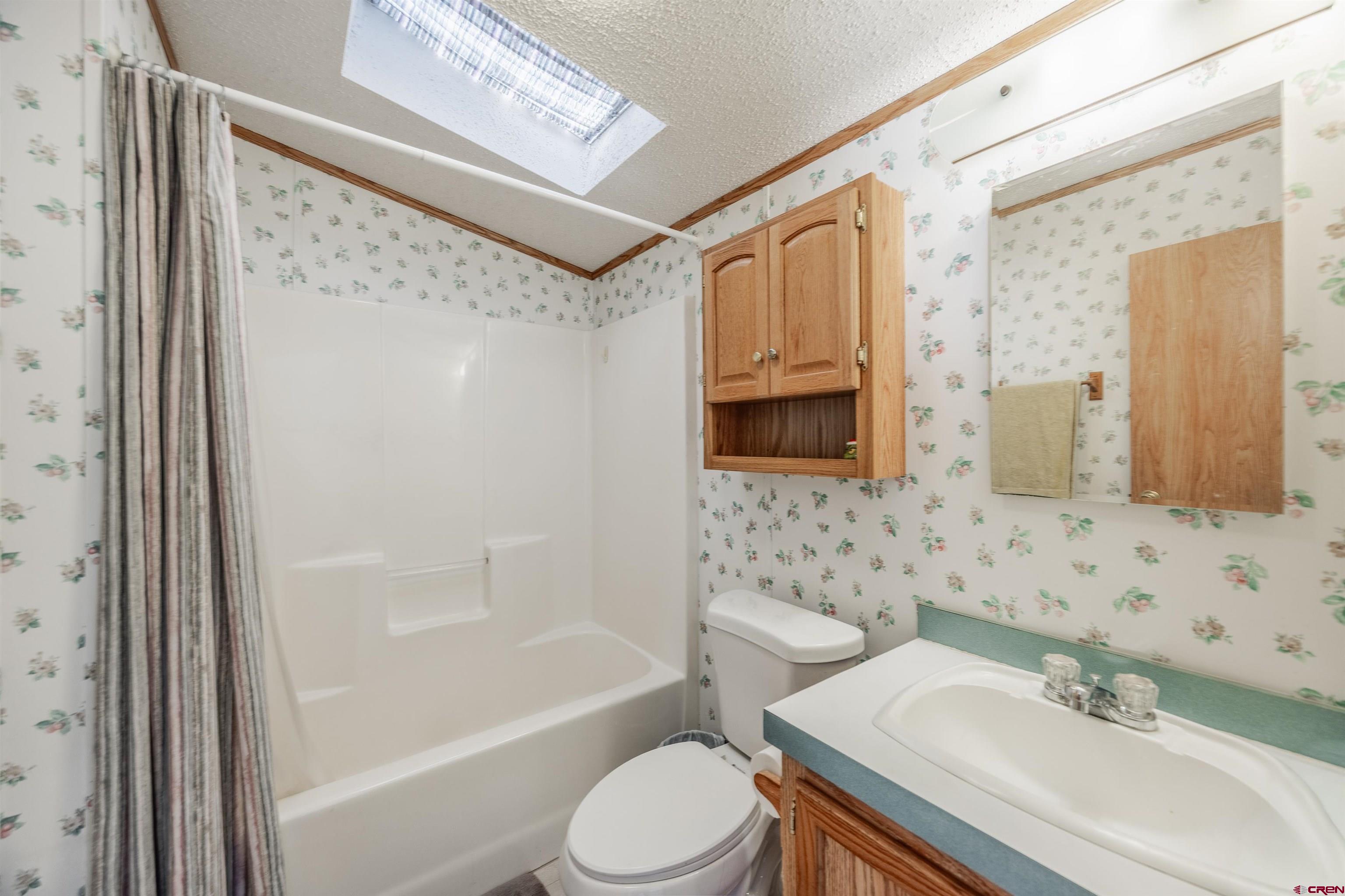 9713 Kebler Road, Unit 28 Austin, CO 81410 - Photo 19 of 25 a bathroom with a sink toilet and shower