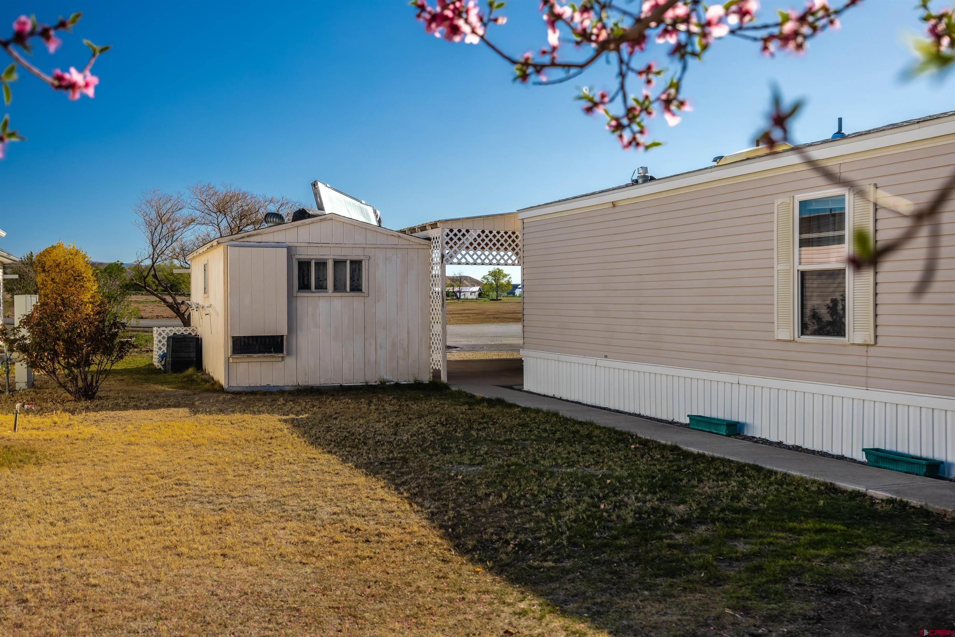 9713 Kebler Road, Unit 28 Austin, CO 81410 - Photo 23 of 25 a front view of a house with a yard