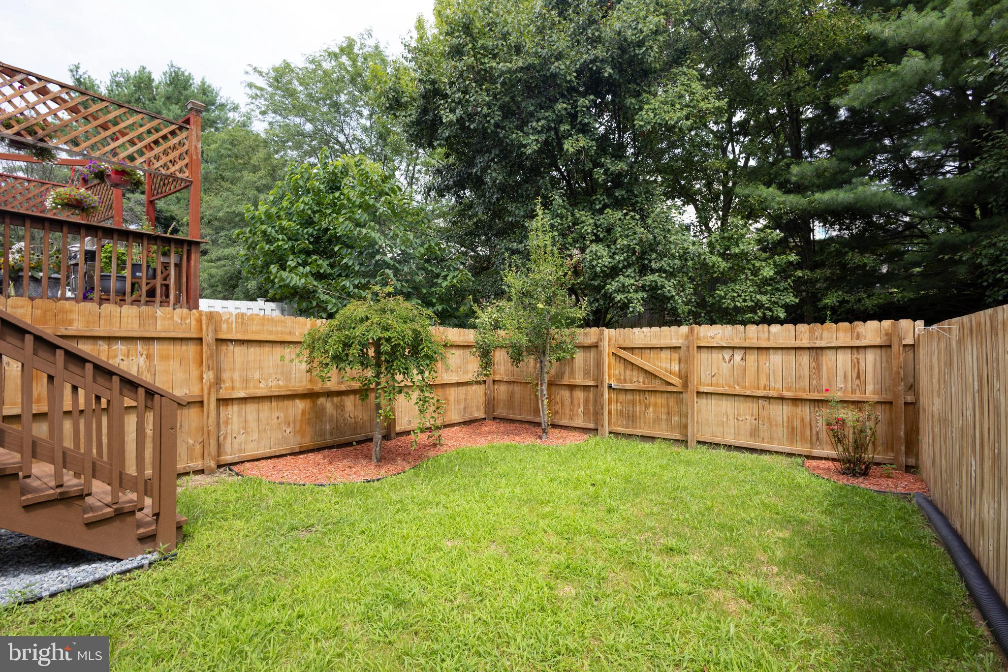 502 Buckstone Garth Abingdon, MD 21009 - Photo 3 of 36 a view of backyard with wooden fence and a bench