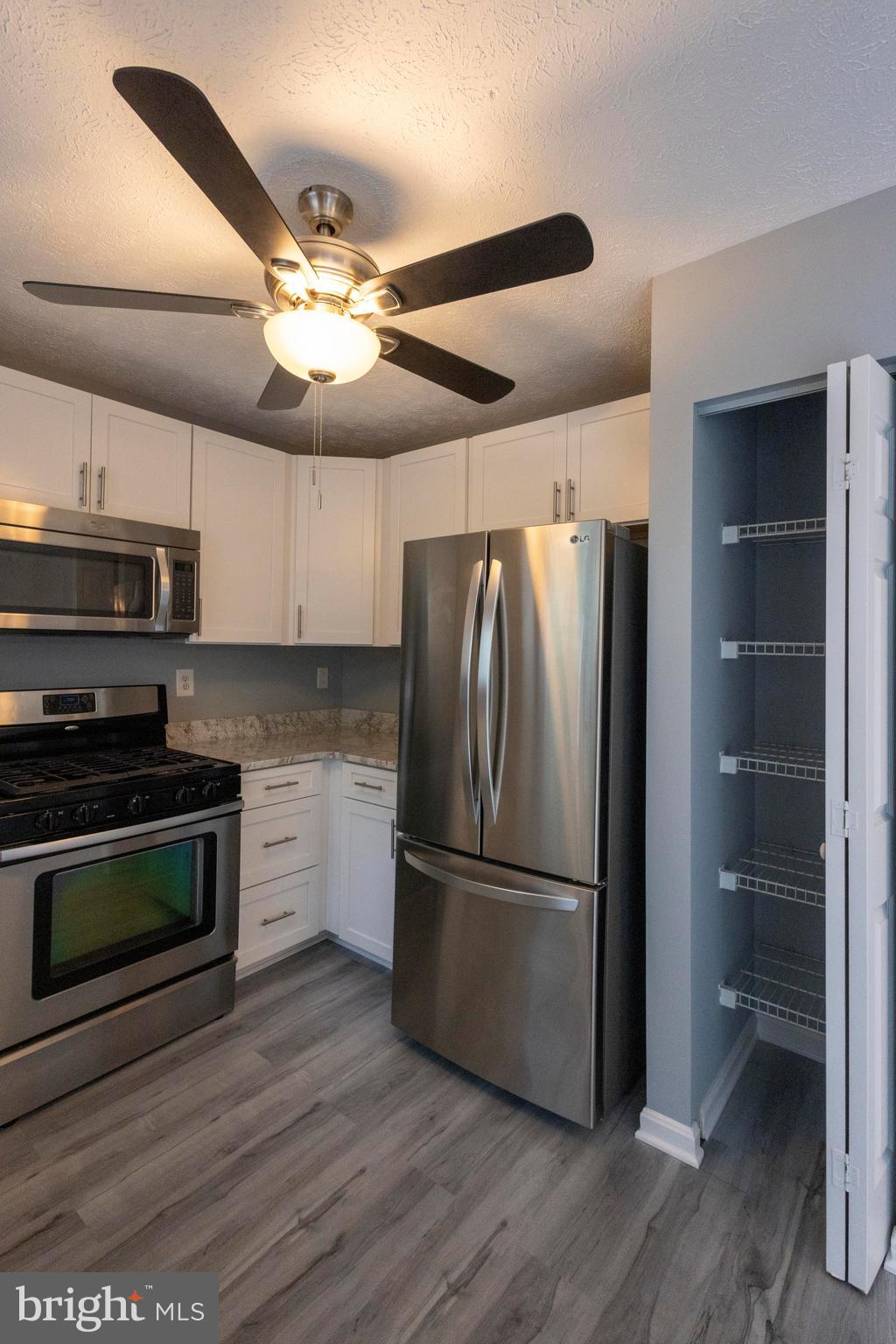 502 Buckstone Garth Abingdon, MD 21009 - Photo 31 of 36 a kitchen with stainless steel appliances granite countertop a refrigerator a stove and a microwave oven