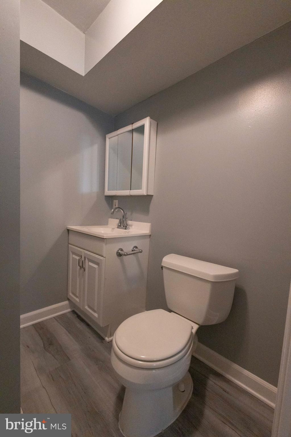 502 Buckstone Garth Abingdon, MD 21009 - Photo 4 of 36 a white toilet sitting next to a bathroom sink and vanity