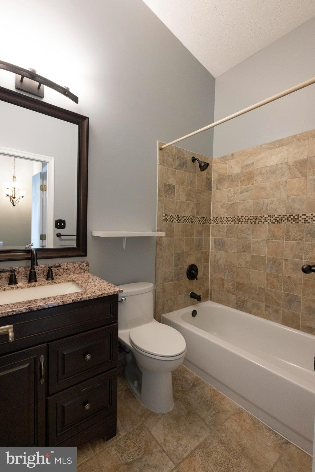 502 Buckstone Garth Abingdon, MD 21009 - Photo 5 of 36 a bathroom with a granite countertop sink a toilet a mirror and shower
