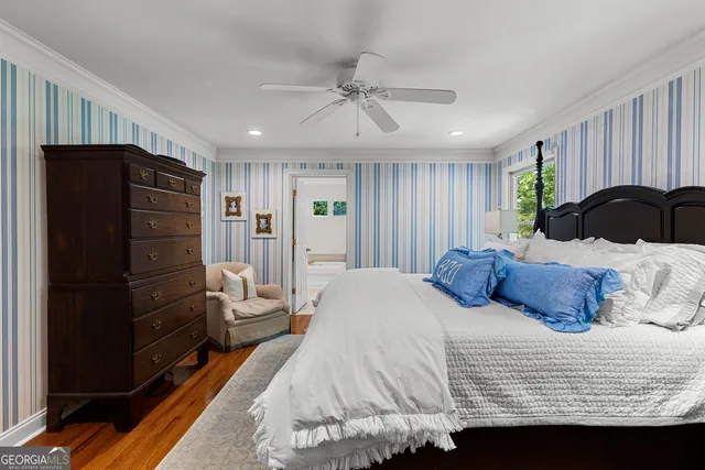 a view of a patio with table and chairs potted plants and a large tree