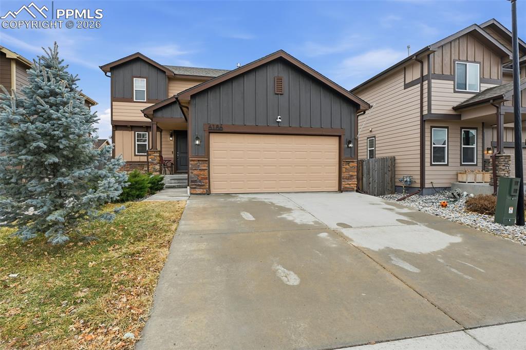 6186 Pilgrimage Road Colorado Springs, CO 80925 - Photo 1 of 20 a front view of a house with a yard and garage