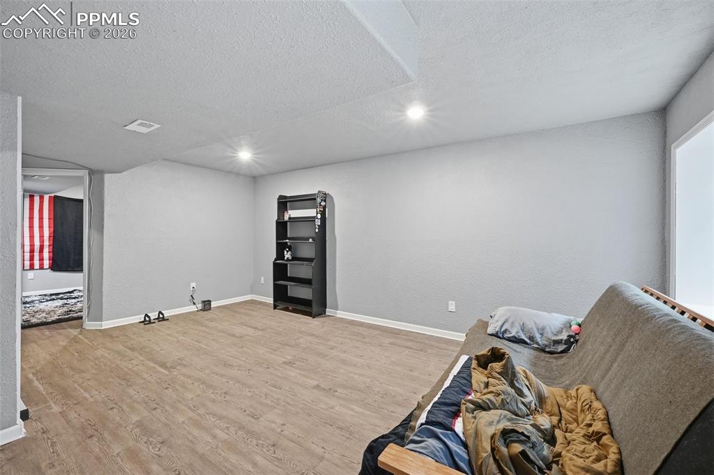 6186 Pilgrimage Road Colorado Springs, CO 80925 - Photo 12 of 20 a bed room with a bed and a tv