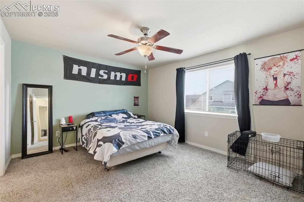6186 Pilgrimage Road Colorado Springs, CO 80925 - Photo 15 of 20 a bedroom with a bed and a window