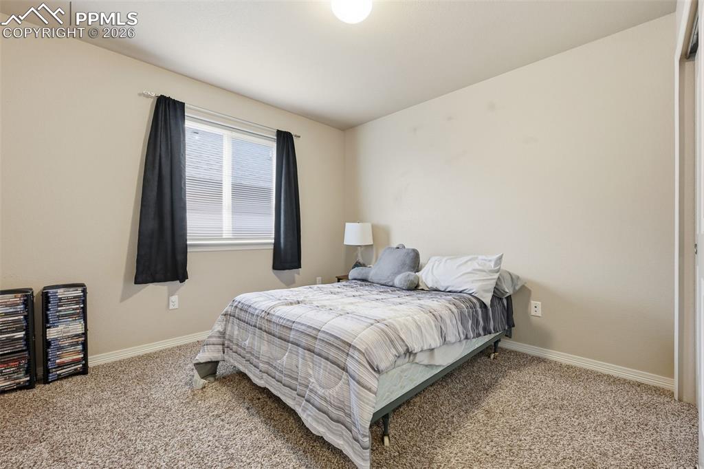 6186 Pilgrimage Road Colorado Springs, CO 80925 - Photo 19 of 20 a bedroom with a bed and window