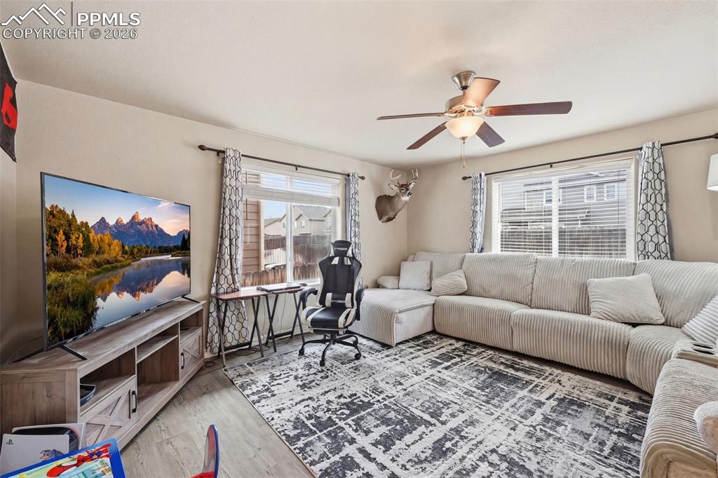 6186 Pilgrimage Road Colorado Springs, CO 80925 - Photo 3 of 20 a living room with furniture and a flat screen tv