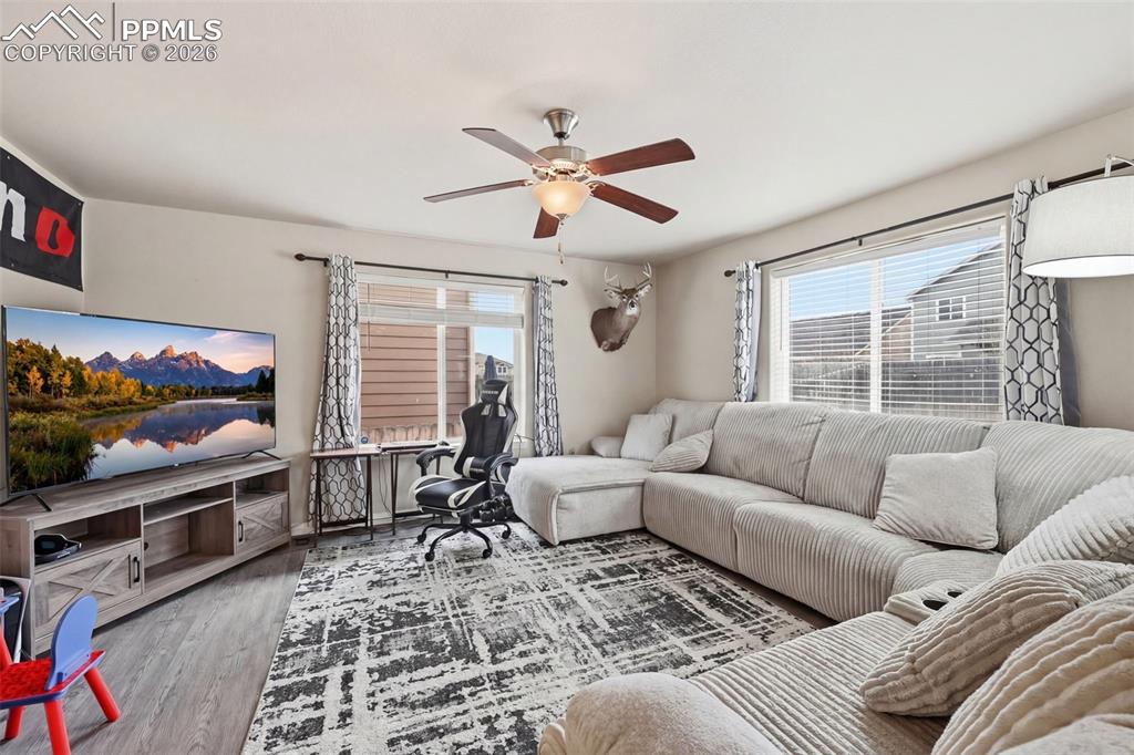 6186 Pilgrimage Road Colorado Springs, CO 80925 - Photo 4 of 20 a living room with furniture ceiling fan and a window