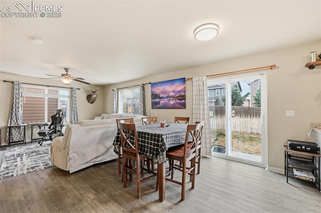 6186 Pilgrimage Road Colorado Springs, CO 80925 - Photo 6 of 20 a view of a dining room with furniture window and wooden floor