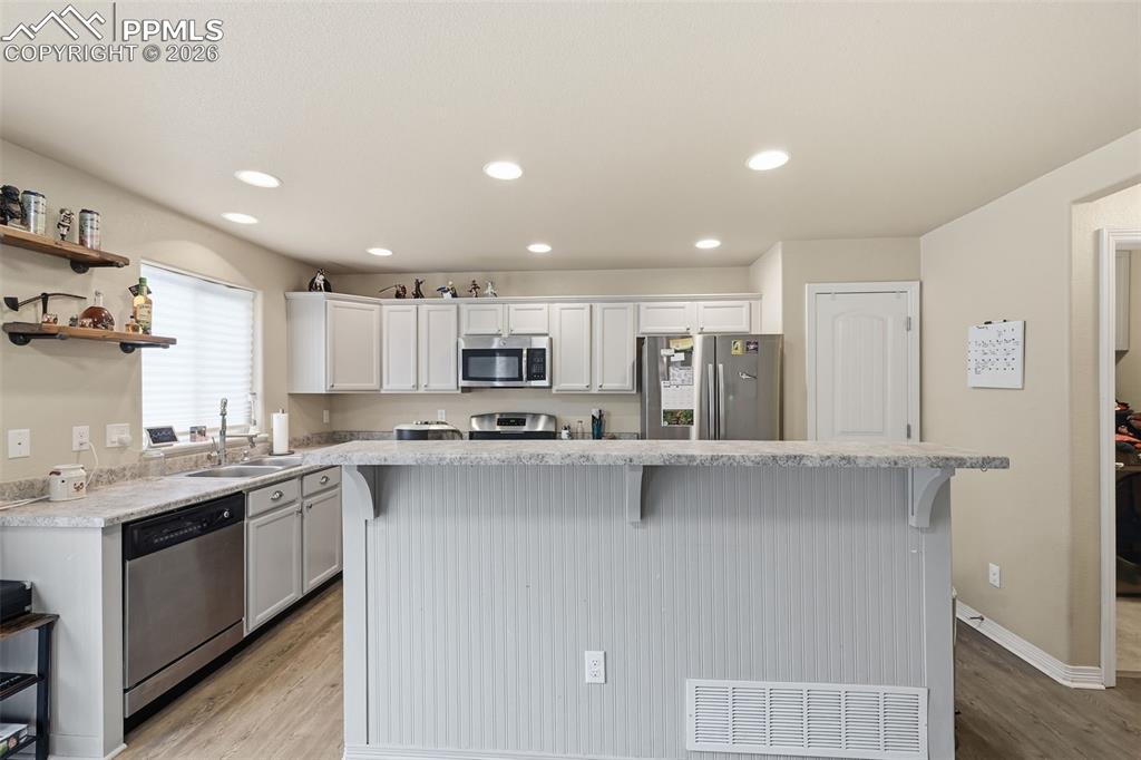6186 Pilgrimage Road Colorado Springs, CO 80925 - Photo 8 of 20 a kitchen with stainless steel appliances a sink stove and refrigerator