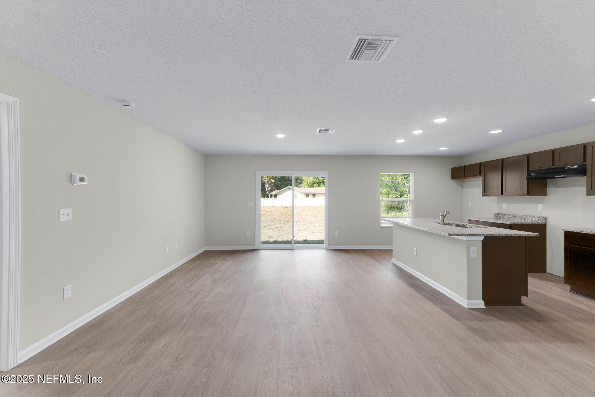 5211 Vernon Road Jacksonville, FL 32209 - Photo 12 of 27 a view of an empty room with a window and kitchen view