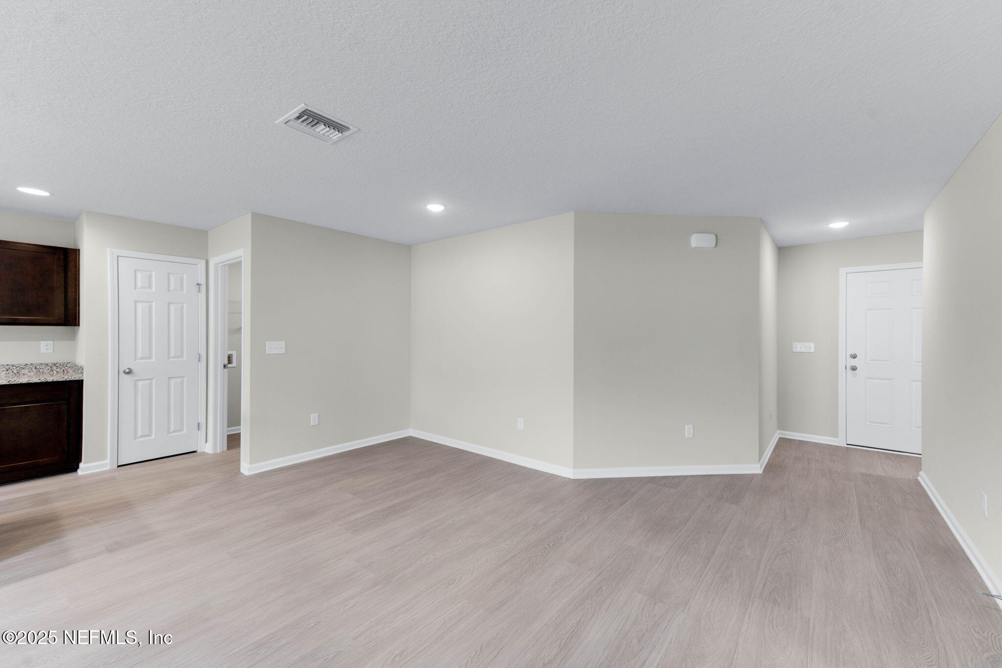 5211 Vernon Road Jacksonville, FL 32209 - Photo 13 of 27 a view of an empty room with wooden floor and a fireplace