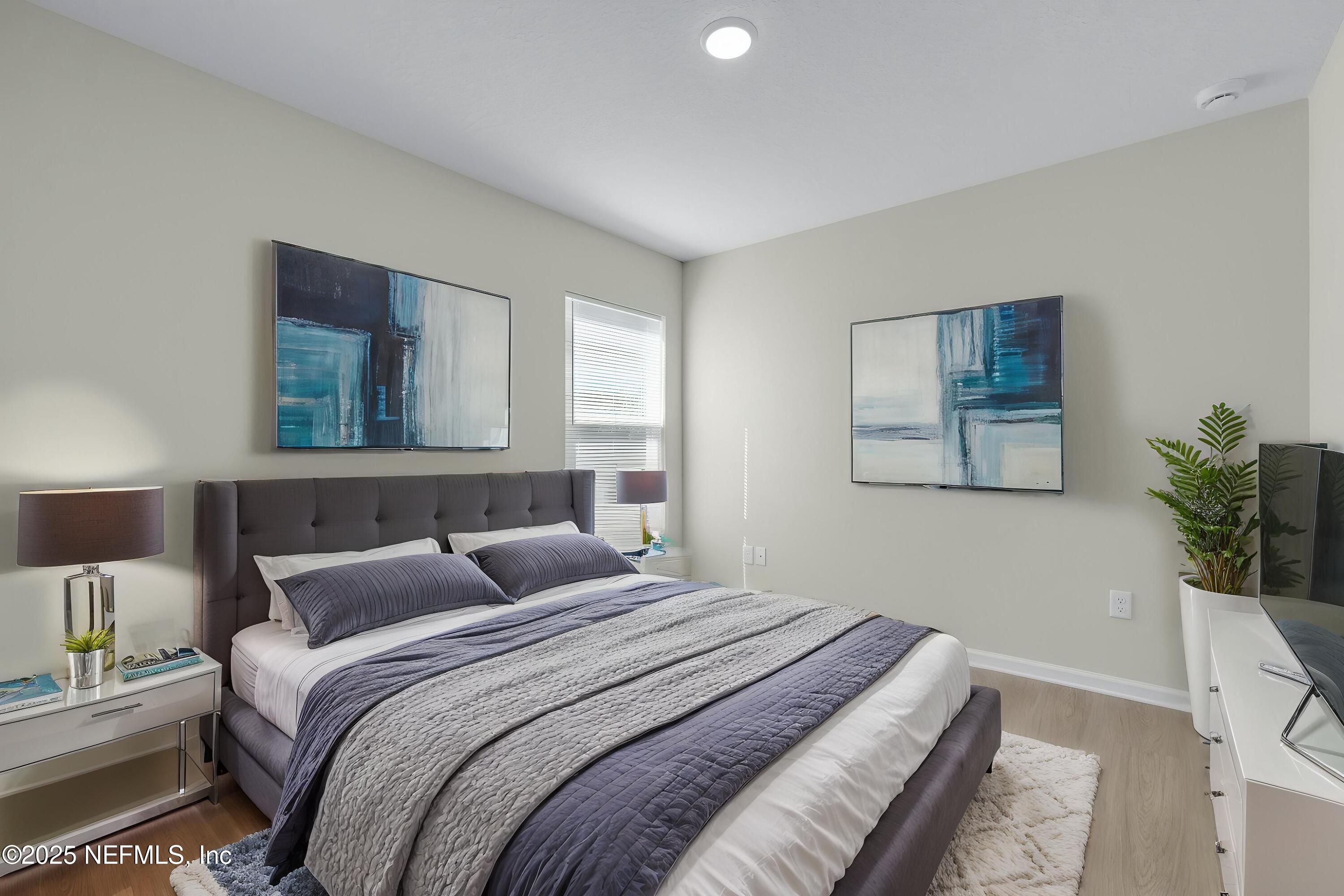 5211 Vernon Road Jacksonville, FL 32209 - Photo 21 of 27 a bedroom with a large bed and a potted plant