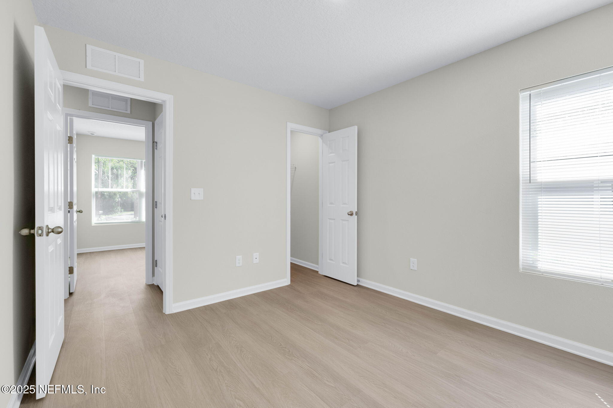 5211 Vernon Road Jacksonville, FL 32209 - Photo 23 of 27 an empty room with wooden floor cabinet and windows