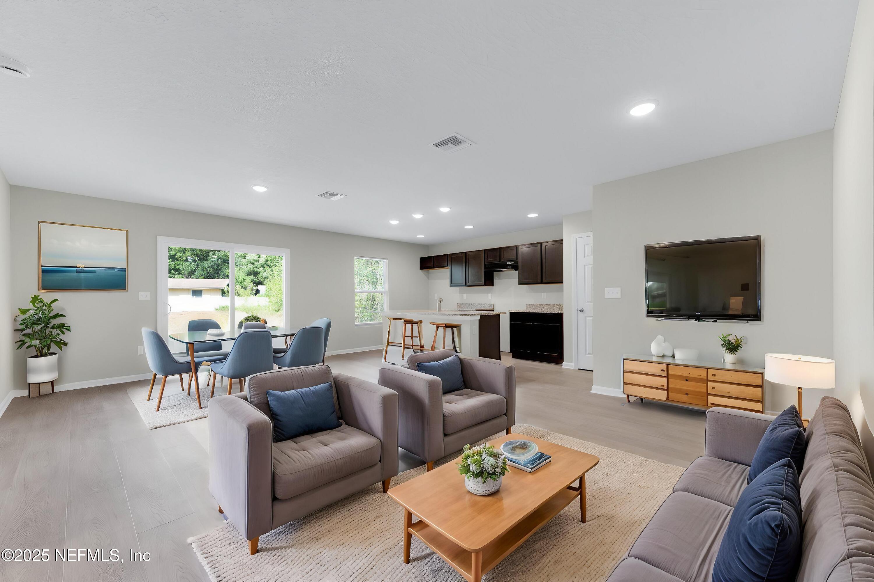5211 Vernon Road Jacksonville, FL 32209 - Photo 5 of 27 a living room with furniture a flat screen tv and a large window