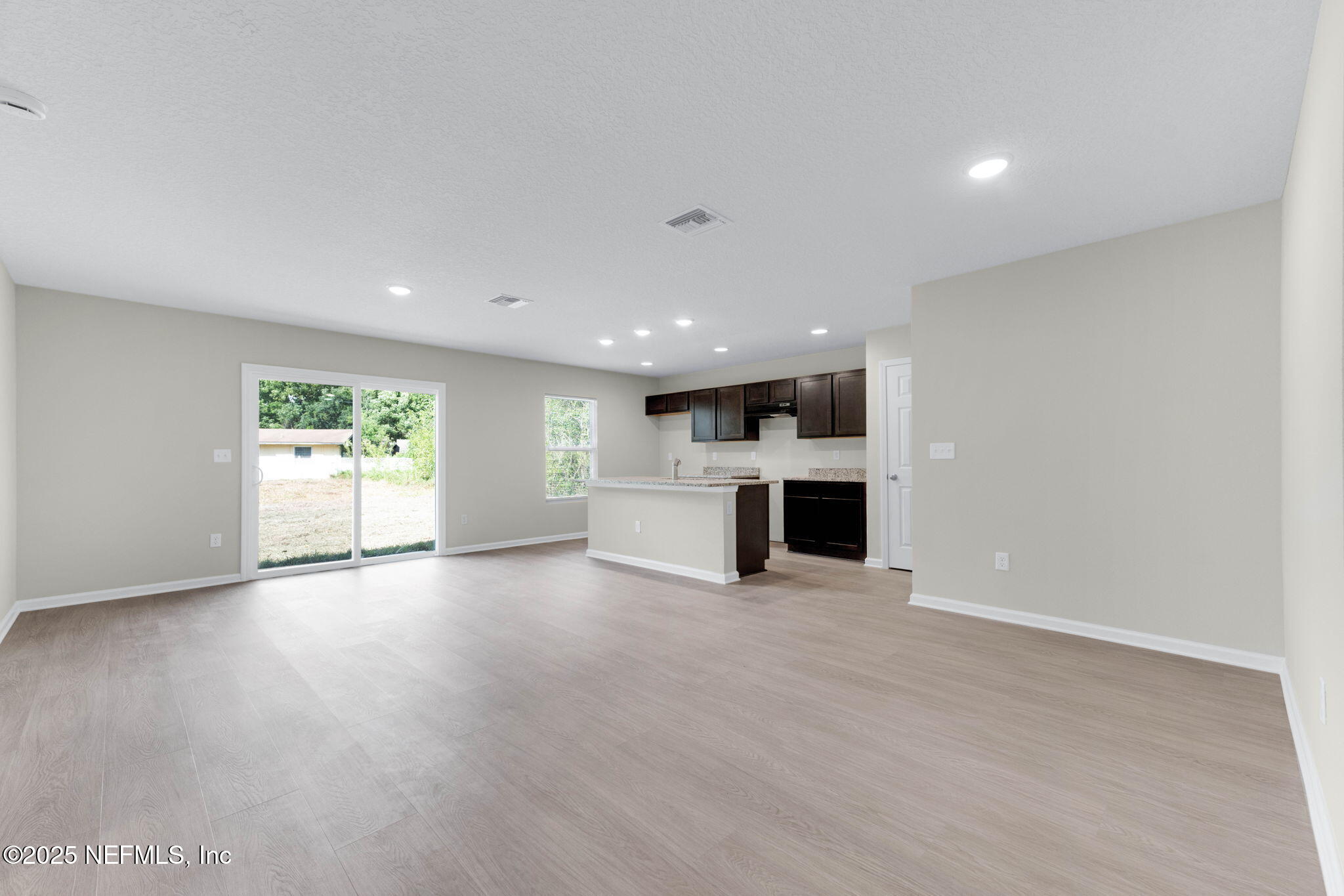 5211 Vernon Road Jacksonville, FL 32209 - Photo 6 of 27 a view of a big room with wooden floor and windows