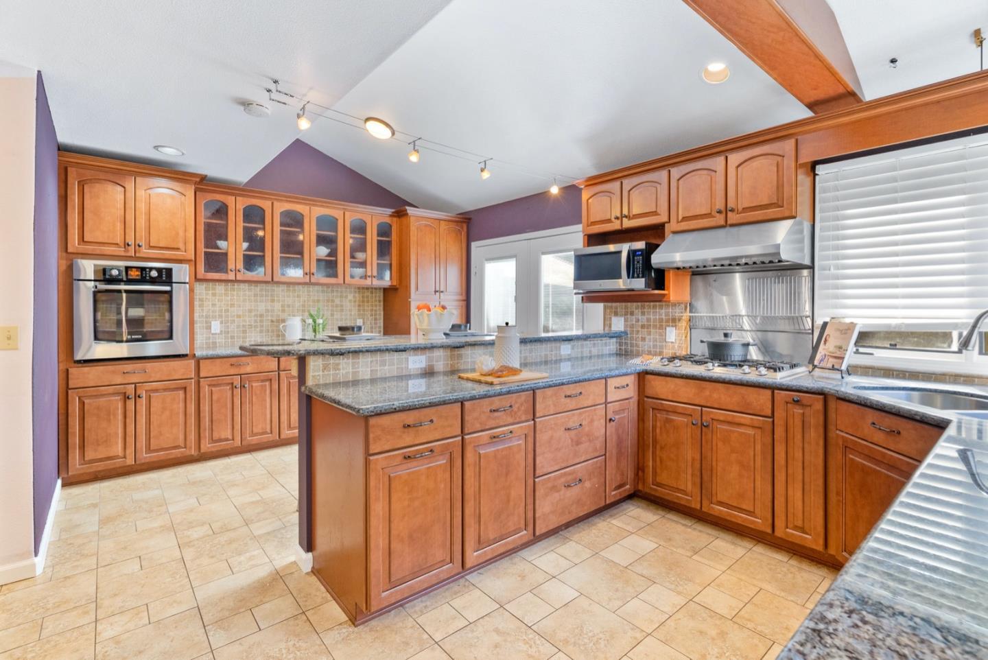 720 Fern Ridge Felton, CA 95018 - Photo 13 of 47 a kitchen with stainless steel appliances granite countertop a stove a sink and a microwave