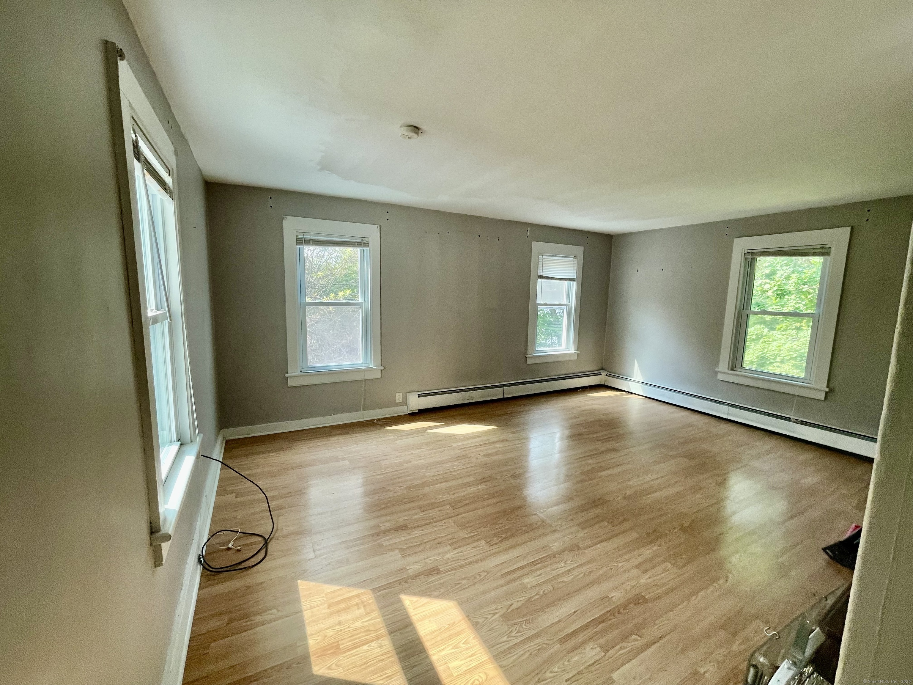 66 Portland Avenue Redding, CT 06896 - Photo 15 of 24 Sunny Living Room upstairs with newer laminate flooring