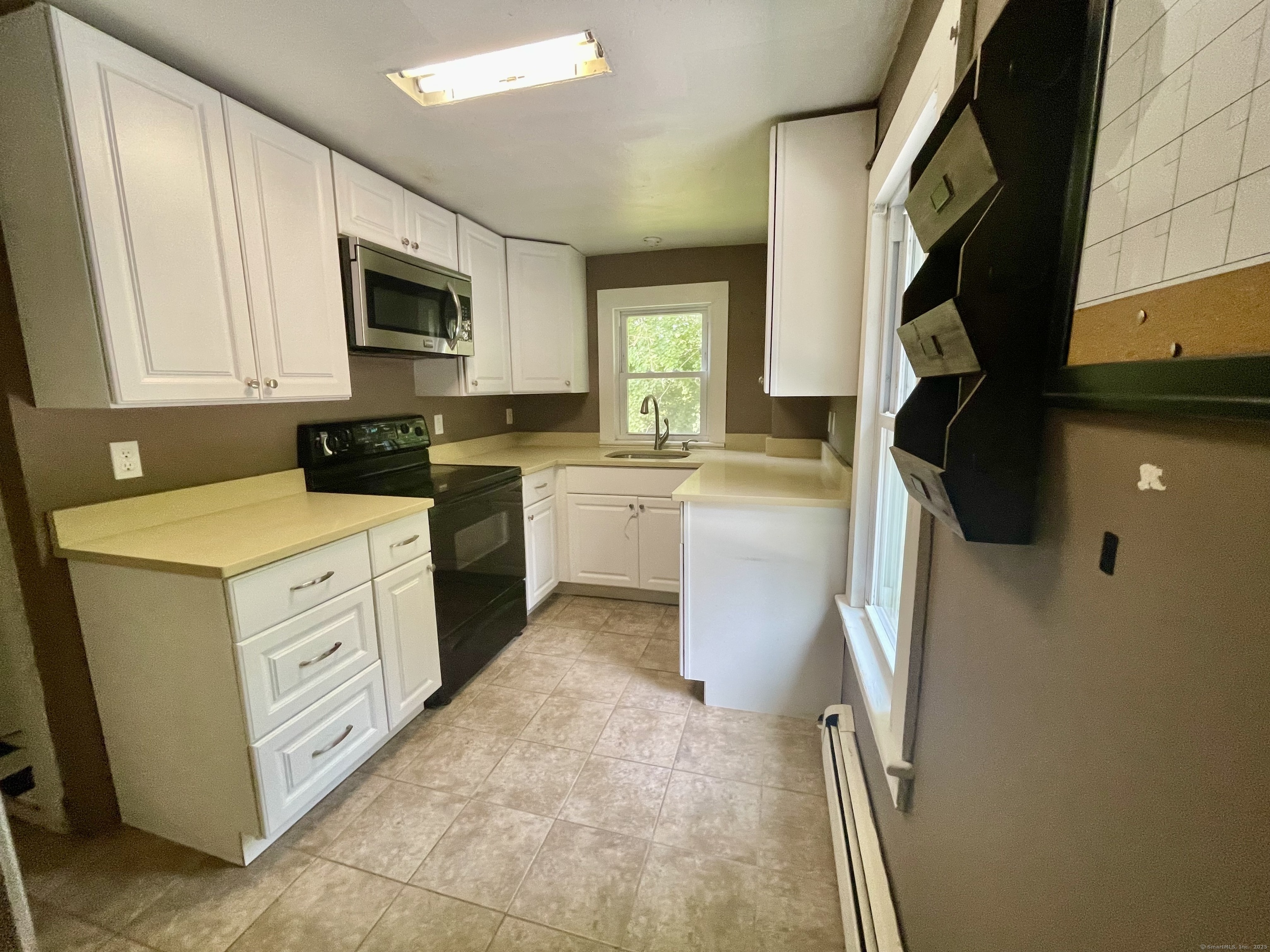 66 Portland Avenue Redding, CT 06896 - Photo 17 of 24 Upstairs remodeled Kitchen with quartz counters & tile floor