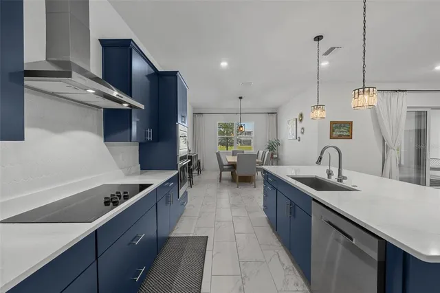 a kitchen with counter top space a sink and appliances