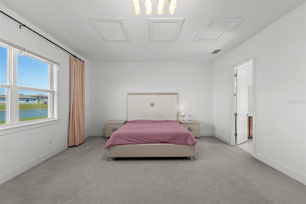 9185 Sanders Tree Loop Wesley Chapel, FL 33545 - Photo 15 of 48 a bedroom with a bed and window