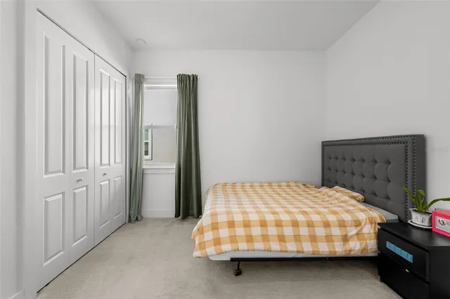 a bedroom with a bed and window