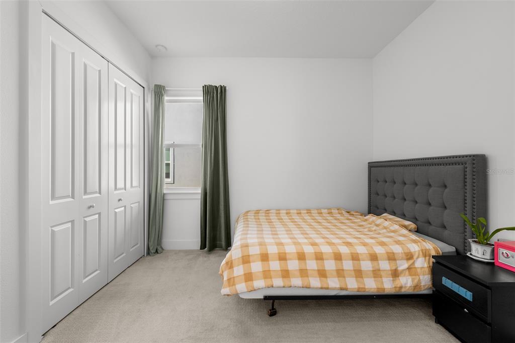 9185 Sanders Tree Loop Wesley Chapel, FL 33545 - Photo 18 of 48 a bedroom with a bed and window